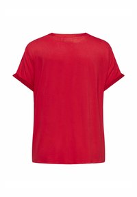 Röd t-shirt med korta ärmar och avslappnad passform, med uppvikta ärmar, tillverkad av ett mjukt och lätt tyg samt med rund halsringning.