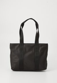 Sac fourre-tout noir en nylon avec deux poignées solides, présentant une surface texturée et un logo en relief. Design simple sans embellissements supplémentaires.