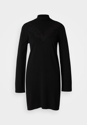 Black knit dress with long sleeves, high neck, and a V-shaped lace trim detail at the chest. Smooth texture, fitted silhouette.