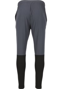 Sportliche Hosen mit einem leichten, dehnbaren grauen oberen Teil und schwarzen unteren Abschnitten, mit einem elastischen Bund und Seitentaschen.