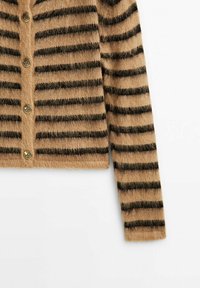 Cardigan marron en maille duveteuse avec des rayures horizontales noires et des boutons dorés, présenté avec une manche longue étendue.