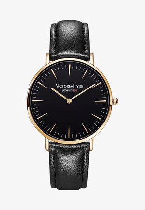 Zwart leren armbandhorloge met een ronde kast in goudkleur, zwart klokwerk en gouden uurmarkeringen. Bevat het logo "Victoria Hyde London."