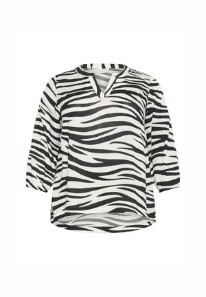 Blouse imprimé zèbre en noir et blanc avec un col en V, des manches 3/4 et une coupe ample. Fabriquée en tissu léger avec une texture lisse.