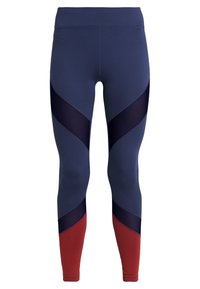 Legíny s vysokým pasem, tmavě modrými síťovanými panely a cihlově červenými barevnými bloky na dolních nohách, navržené pro sportovní nošení.