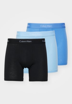 Puuvilla bokserid mustas, helesinis ja sinises värvitoonis. Igaühel on elastne vöökoht, millel on kontrastse värvi "Calvin Klein" logo.