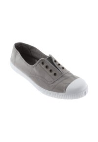 Zapato tipo slip-on de lona gris con puntera y suela exterior de goma blanca; cuenta con ojales para ventilación y una parte superior textil lisa.