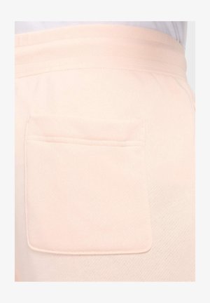 Pantalones deportivos de color rosa claro con un único bolsillo parche en la parte trasera, confeccionados en un suave tejido texturizado y con una cintura elástica.