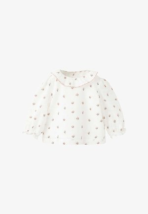 Blouse blanche pour bébé à manches longues avec petit motif floral rose, col à volants bordé de rose et poignets à volants.