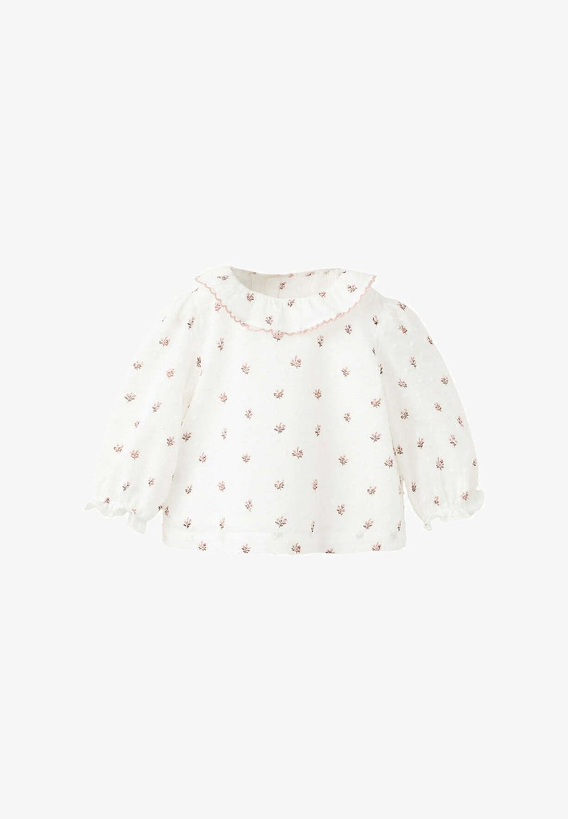 Blouse blanche pour bébé à manches longues avec petit motif floral rose, col à volants bordé de rose et poignets à volants.