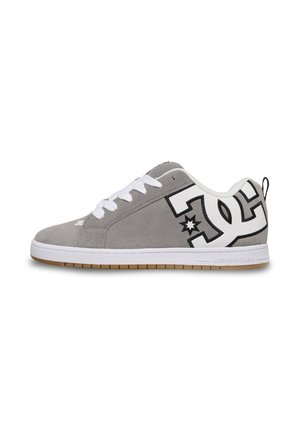 Gray suede low-top sneaker with white laces, large white and black logo on heel, and white sole with gum-colored tread.