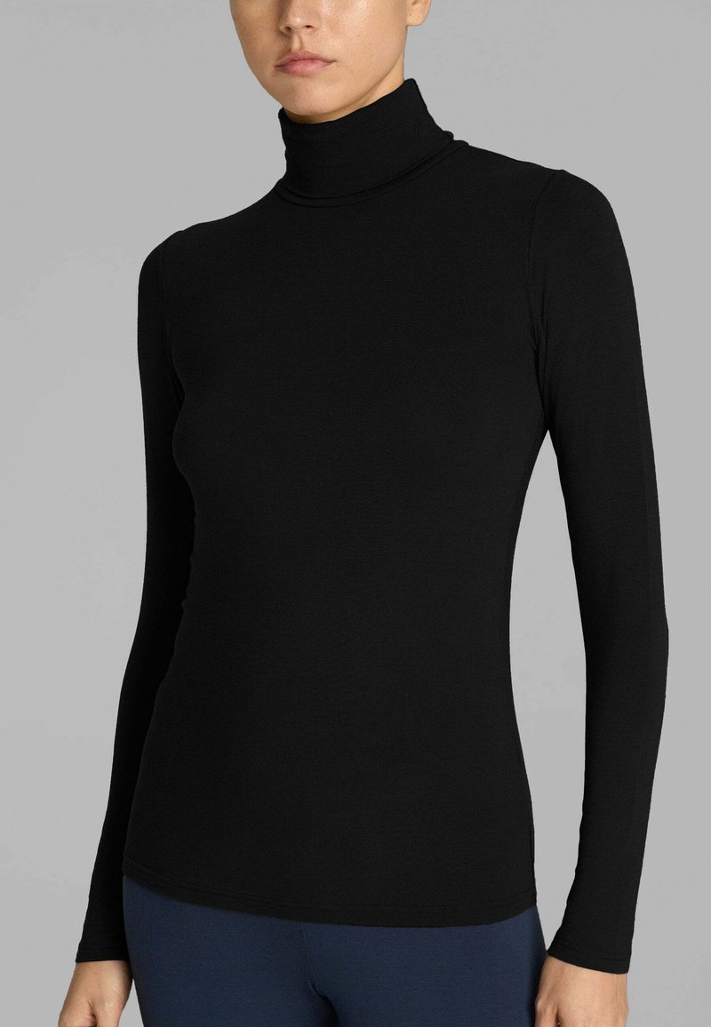 Maglioncino a maniche lunghe nero con collo alto, realizzato in un tessuto liscio ed elastico, caratterizzato da un design aderente e da cuciture minime per un aspetto elegante.