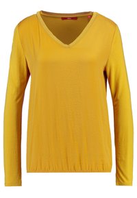 Langermige mosterdgele V-hals shirt met elastische zoom, effen stof en zichtbaar rood merklabel aan de binnenkant van de kraag.