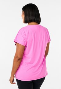 Pink short-sleeve t-shirt made of smooth fabric. The back features a rounded neckline and relaxed fit, with a slight curvature at the hem.
