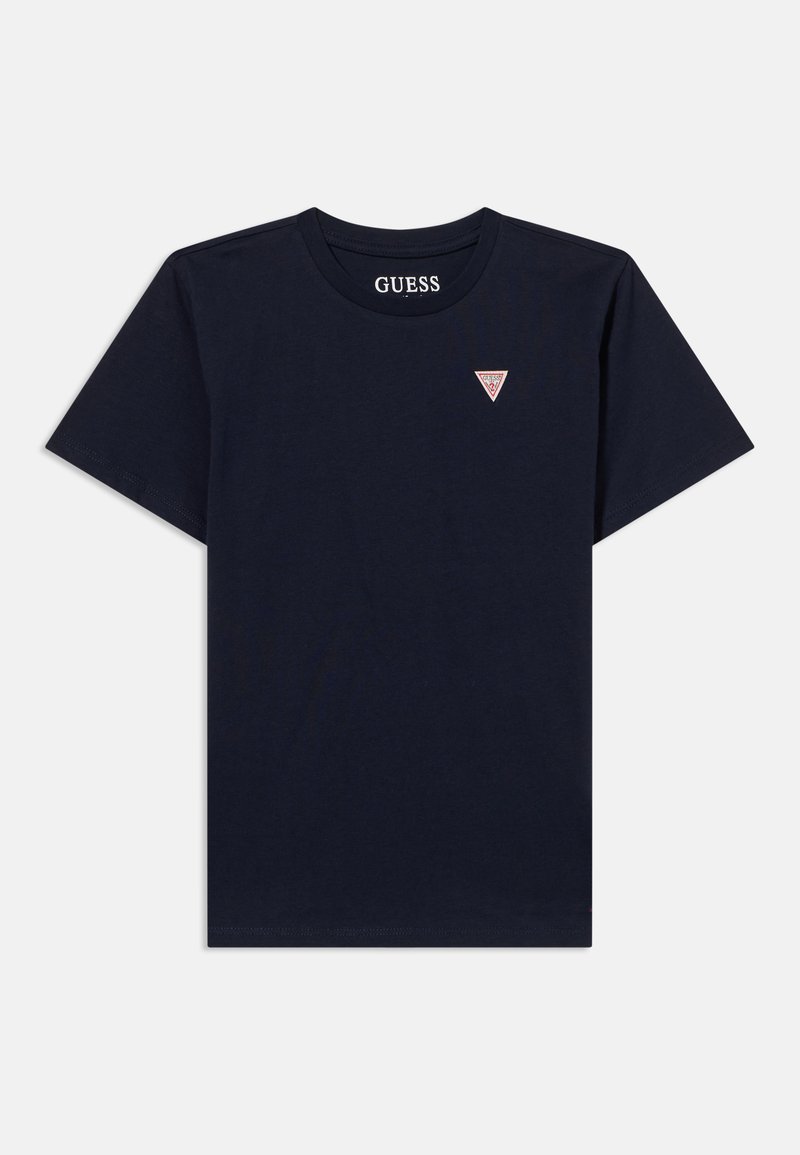 T-shirt noir à manches courtes avec col rond et petit logo Guess en forme de triangle rouge et blanc sur la poitrine gauche.