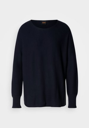 Granatowy sweter z dzianiny z szerokim okrągłym dekoltem, długimi rękawami, ściągaczami na mankietach, rozcięciami po bokach oraz swobodnym krojem. Widoczna metka z logo przy szyi.