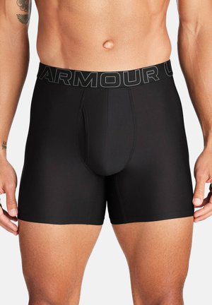 Black boxer briefs with a fitted design, textured fabric, and a wide elastic waistband featuring "ARMOUR" in contrasting letters.