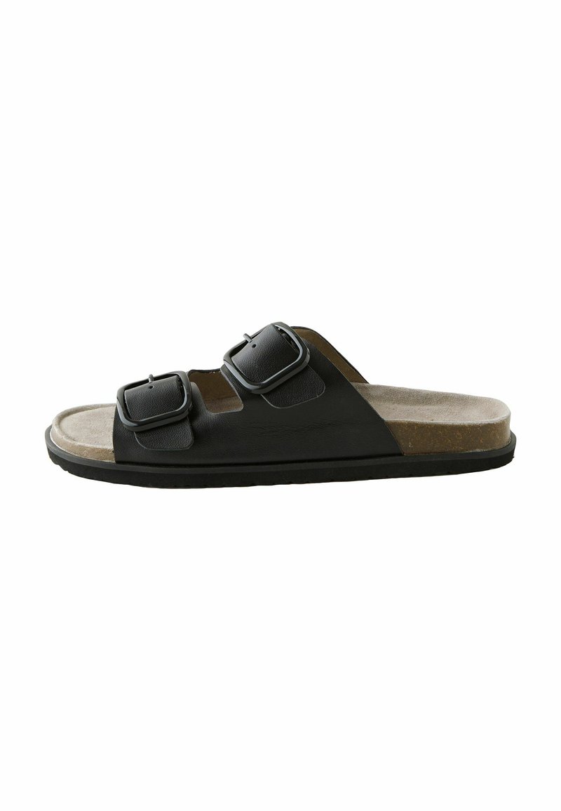 Schwarze Zehentrenner-Sandale mit zwei Riemen und verstellbaren Schnallen, Korkfußbett und Gummisohle. Glattes Leder und weiche Wildledertexturen.