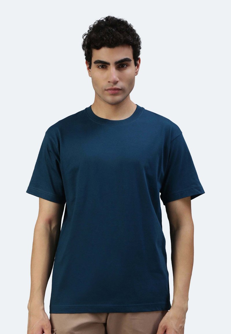 T-shirt in cotone blu navy con maniche corte, scollatura rotonda e una texture liscia. Nessun motivo o grafica visibile.