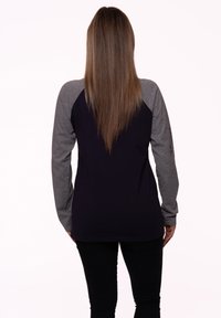 Long-sleeve shirt with a dark purple body and gray raglan sleeves, made of a smooth fabric, featuring a curved hem and no visible patterns.