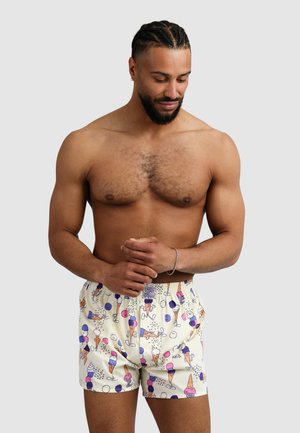 Boxer shorts featuring a light cream fabric with a colorful ice cream cone pattern, elastic waistband, and a relaxed fit.