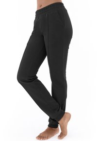 Schwarze Jogginghose aus weichem Baumwollmix, mit elastischem Bund, Seitentaschen und schmal zulaufenden Säumen für eine enganliegende Passform.