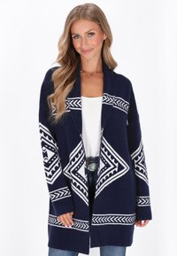 Cardigan navy con motivi geometrici bianchi, apertura frontale, maniche lunghe e vestibilità rilassata. Realizzato in tessuto tricot texturizzato.