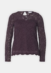 Langer Spitzenblusentop mit langen Ärmeln in tiefem Lila, floralem Muster, gewelltem Saum und Details mit Schlüsselloch im Rücken. Transparente Spitzenstruktur und figurbetontes Design.