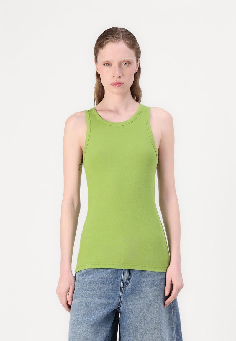Green ribbed tank top with a round neckline and sleeveless design, paired with loose-fitting blue denim shorts. Smooth texture.