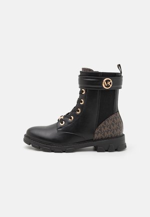 Black leather ankle boot with gold eyelets, padded collar, and elastic side panel featuring a brown pattern. Round toe, chunky rubber sole.