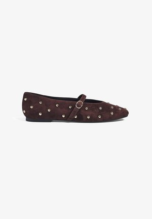 Burgundy suede flat shoe with a rounded toe, decorative gold-tone studs, and a slim ankle strap with a metal buckle. Low profile sole.