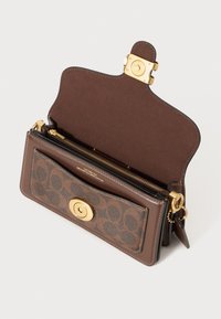 Brown leather wallet with a gold-tone clasp, featuring a patterned exterior and zippered pockets. Interior has a smooth brown lining.