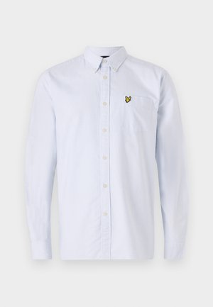 Light blue striped button-up shirt with a small yellow logo on the chest pocket. Features a classic collar and long sleeves. Cotton material.