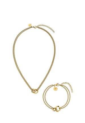 Gold-tone double chain necklace and matching bracelet, each with two interlocking loop pendants and adjustable clasps.