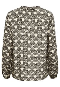Lengte mouwen blouse met een zwart bladerenpatroon op een crèmekleurige achtergrond, gemaakt van lichtgewicht stof. Heeft een ronde halslijn en elastische manchetten.