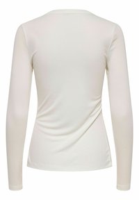 Maglietta a maniche lunghe aderente in un morbido tessuto a coste di crema chiara. Presenta un colletto rotondo e una texture liscia con una leggera curvatura sul retro.