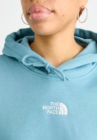 The North Face ESSENTIAL CROP HOODIE - Melegítőfelső - algae blue