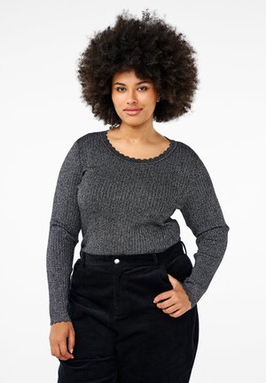 Gray ribbed knit sweater with a scalloped neckline, paired with black corduroy pants, featuring a relaxed fit and long sleeves.