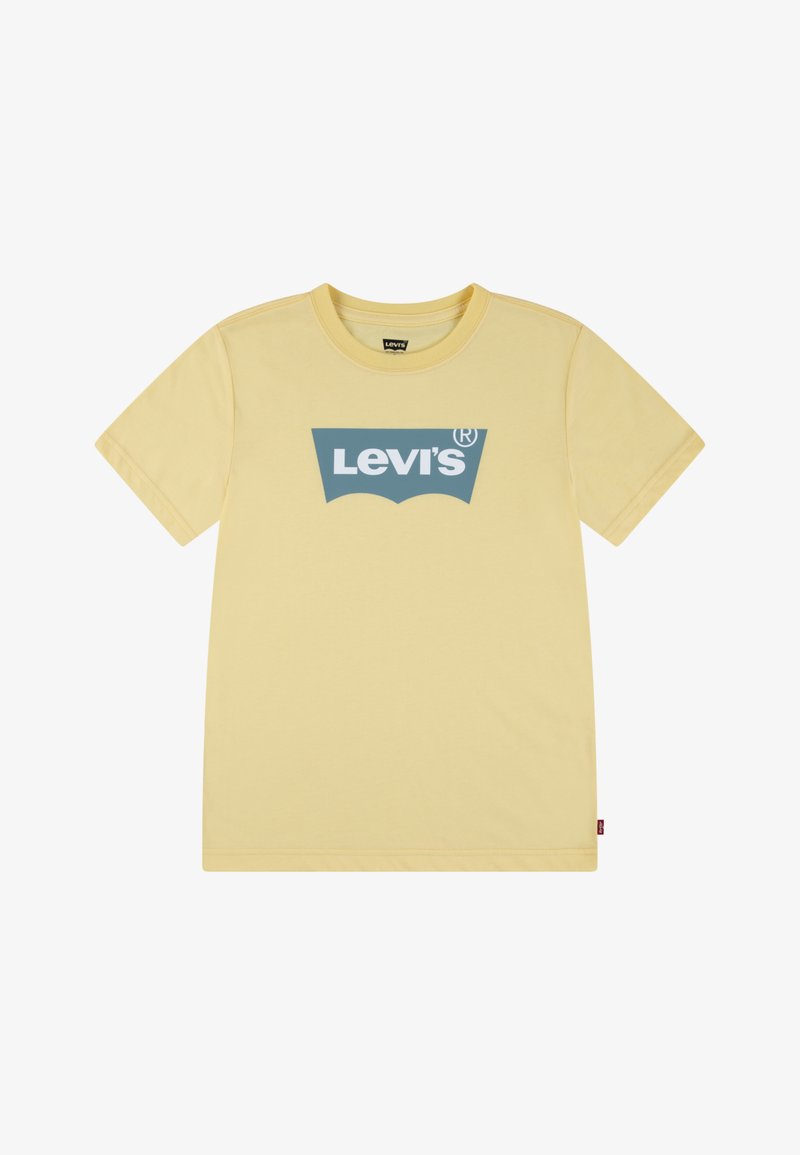 T-shirt de algodão amarelo com mangas curtas, apresentando um logo azul da Levi's ao centro. Gola redonda e uma etiqueta vermelha na costura lateral.