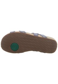 Brown rubber sole with herringbone pattern, featuring blue straps and a cork-like footbed. Green logo embossed on the underside.