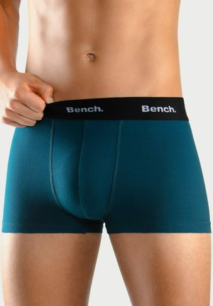 Teal cotton blend boxer briefs with a black elastic waistband featuring "Bench." logo. Smooth texture, form-fitting cut, and reinforced stitching.