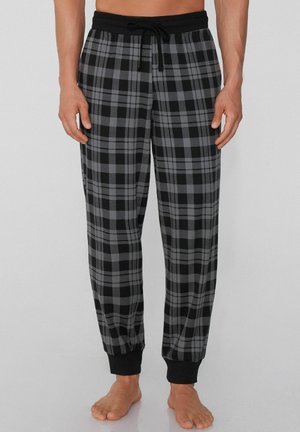 Schwarze und graue karierte Schlafanzughosen mit einem elastischen Bund, Kordelzug und elastischen Bündchen an den Knöcheln. Weicher Stoff.