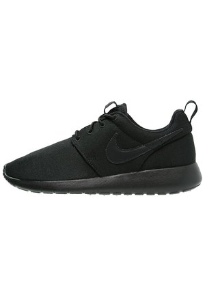 Black Nike shoes with a canvas upper, lace-up design, round toe, and textured outsole. Logo in matching color on the side.