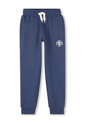 Pantalon de jogging bleu marine avec cordon de serrage blanc, poignets côtelés, poches latérales et logo Timberland avec graphique d'arbre et "1973" sur la cuisse gauche.