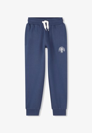 Pantalon de jogging bleu marine avec cordon de serrage blanc, poignets côtelés, poches latérales et logo Timberland avec graphique d'arbre et "1973" sur la cuisse gauche.