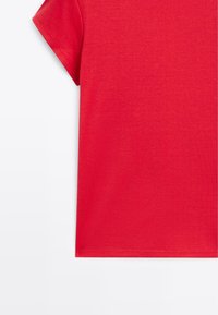Bright red short-sleeve t-shirt cropped to show upper sleeve and torso against a plain white background.
