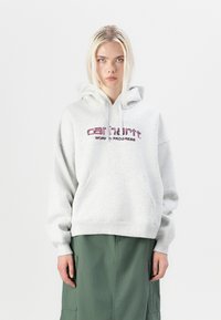 Light gray hooded sweatshirt with front pocket, featuring pink embroidered "carhartt" and "WORK IN PROGRESS" text. Loose-fit design, cotton material.