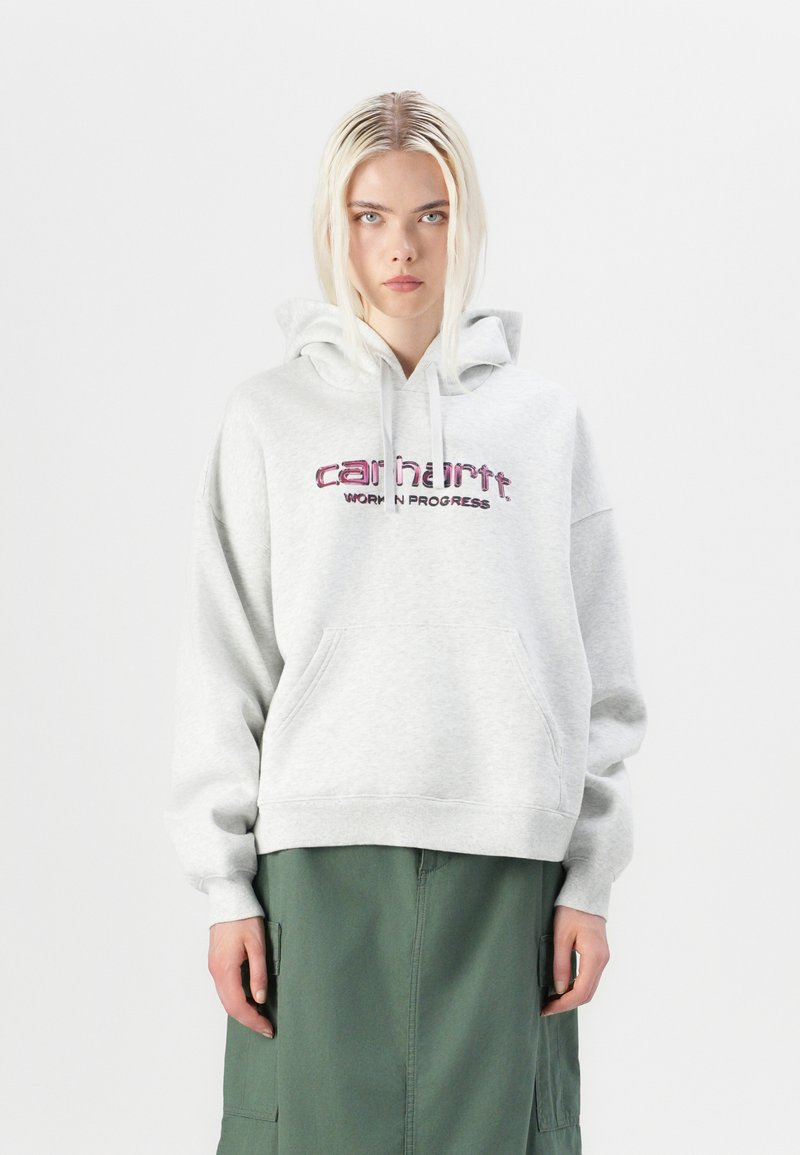 Light gray hooded sweatshirt with front pocket, featuring pink embroidered "carhartt" and "WORK IN PROGRESS" text. Loose-fit design, cotton material.