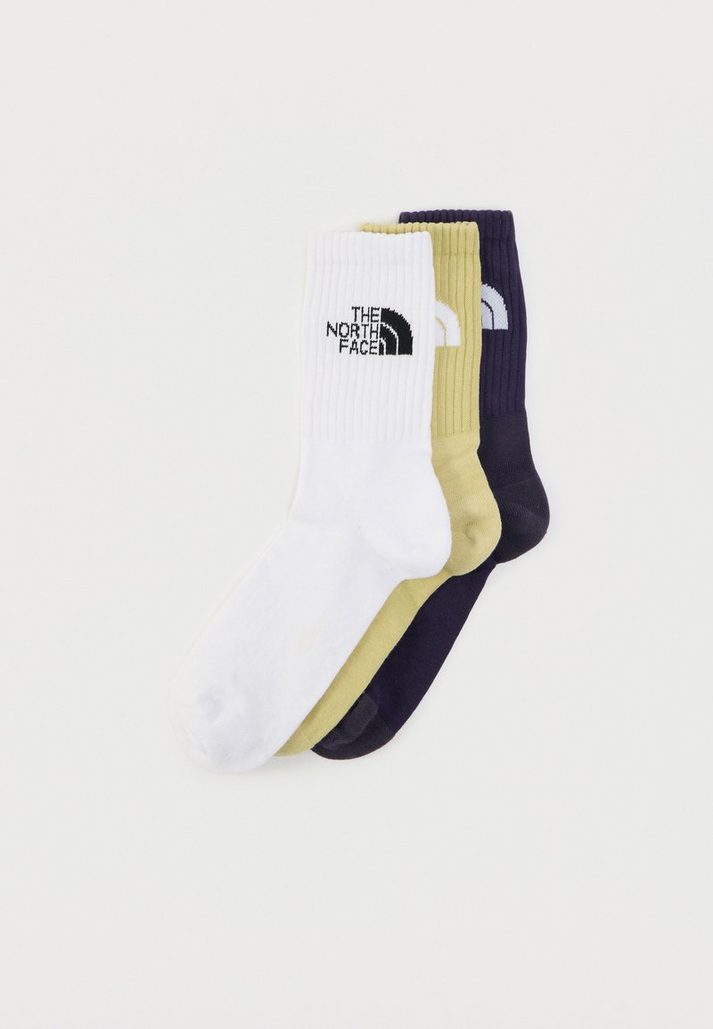 Τρία ζευγάρια κάλτσες για πλήρωμα σε λευκό, ελιά πράσινο και σκούρο μωβ. Κάθε ένα έχει πλεκτή υφή με λογότυπο στην λευκή κάλτσα.