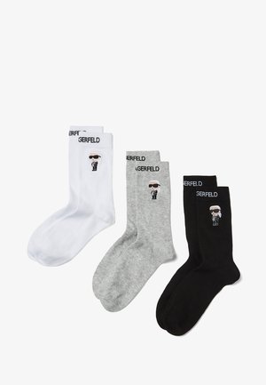 Three pairs of socks: white, gray, and black. Each features a cartoon figure with sunglasses, with "GERFELD" logo on the cuff.