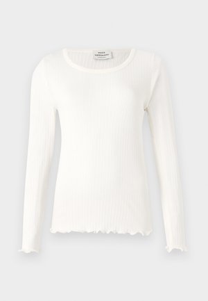 Pikema varrukatega valge ribakujuline tekk, millel on ümar dekoltee ja lainelised servad. Valmistatud pehmest kangast, millel on liibuv siluett. Brändi silt on nähtav.